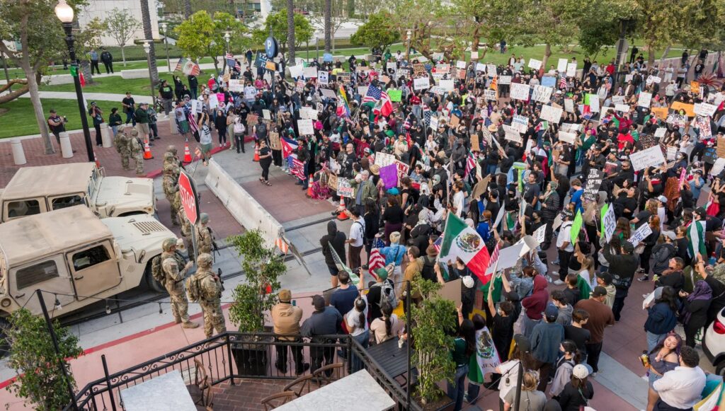 Protesters stand opposite the California National Guard outside the Ronald Reagan Federal Building and Courthouse in Santa Ana, on June 11th.Photograph by Leonard Ortiz / MediaNews Group / Orange County Register / Getty